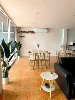 a living room with a table and a couch at MONTANA Hotel & Hostel Phuket in Karon Beach