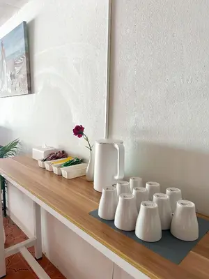 a group of white vases sitting on a table at MONTANA Hotel & Hostel Phuket in Karon Beach