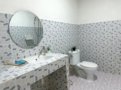 a bathroom with a sink and a toilet and a mirror at MONTANA Hotel & Hostel Phuket in Karon Beach