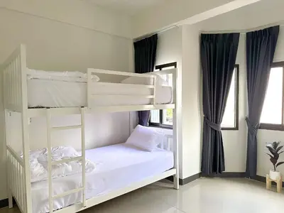 a bedroom with two bunk beds in a room at MONTANA Hotel & Hostel Phuket in Karon Beach