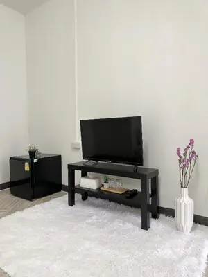 a living room with a flat screen tv on a table at MONTANA Hotel & Hostel Phuket in Karon Beach