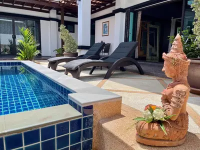 a swimming pool with a statue next to a house at Siam Jewel - Private pool villa in Bang Tao in Bang Tao Beach