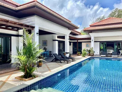 a villa with a swimming pool and a house at Siam Jewel - Private pool villa in Bang Tao in Bang Tao Beach