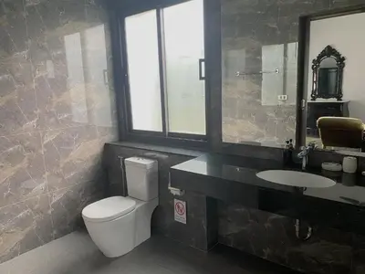 a bathroom with a toilet and a sink and a mirror at Siam Jewel - Private pool villa in Bang Tao in Bang Tao Beach