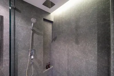 a shower with a shower head in a bathroom at 5 Stars Facilities Condo Kamala Beach in Kamala Beach