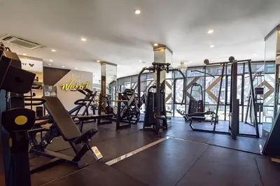 a gym with treadmills and machines in a building at 5 Stars Facilities Condo Kamala Beach in Kamala Beach