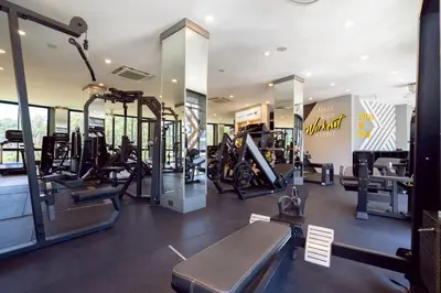 a gym with treadmills and elliptical machines at 5 Stars Facilities Condo Kamala Beach in Kamala Beach