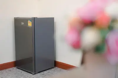 a black refrigerator in a corner of a room at Kai Mook House in Ban Ket Ho