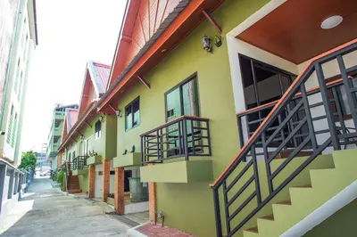a building with balconies on the side of a street at Kai Mook House in Ban Ket Ho